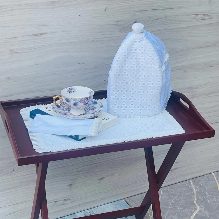 Pure Elegance White Napkin (single piece) Step into a dreamy ambiance with our Pure White Table Mat, adorned with a beautiful white edging. Measuring 16 by 16 inches, it's the perfect enchanting touch for any occasion, adding a whimsical elegance to your dining experience. "Versatile and timeless, our Pure White Table Mat complements any tea set or tableware effortlessly. With its understated elegance, it seamlessly blends with any decor, adding a touch of sophistication to every table setting.
